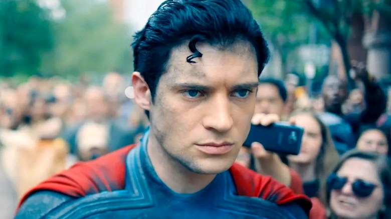Superman walks past a crowd of people in Superman (2025)
