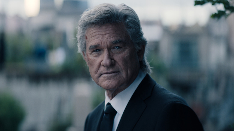 Lee Shaw wearing a suit and looking grim at Hiroshi Randa's funeral in Monarch: Legacy of Monsters Season 2 (2026)