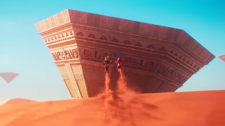 Mario and Luigi jumping a sand dune on bikes