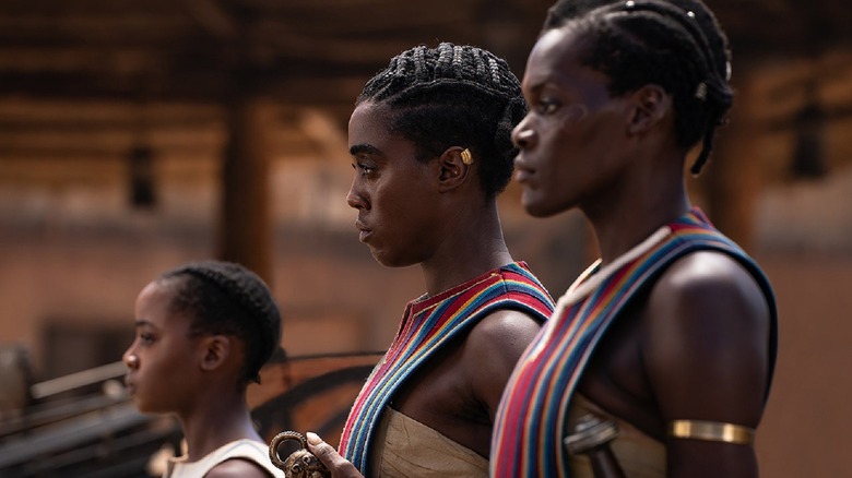 Lashana Lynch standing with warriors