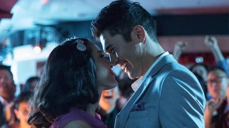Rachel and Nick smiling while touching noses in "Crazy Rich Asians"