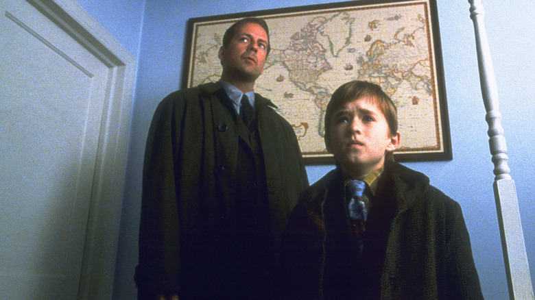 Malcolm Crowe and Cole Sear looking at an odd situation in "The Sixth Sense"