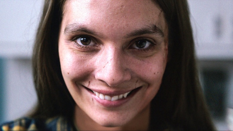 Caitlin Stasey's Laura Weaver smiling in Smile