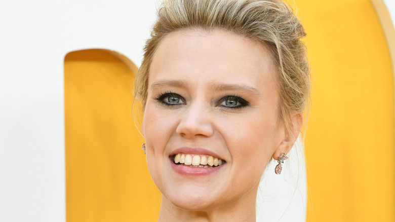 Kate McKinnon smiling at a red carpet event