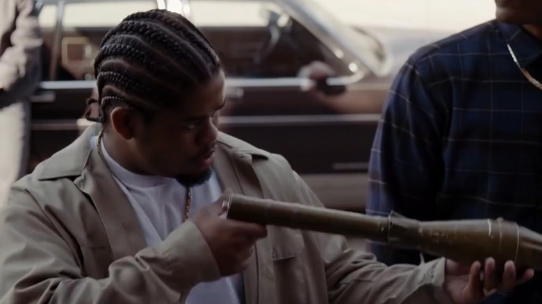 Leon Simmons examining a weapon