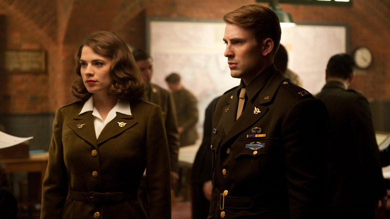 Steve Rogers and Peggy Carter standing next to each other in military uniforms