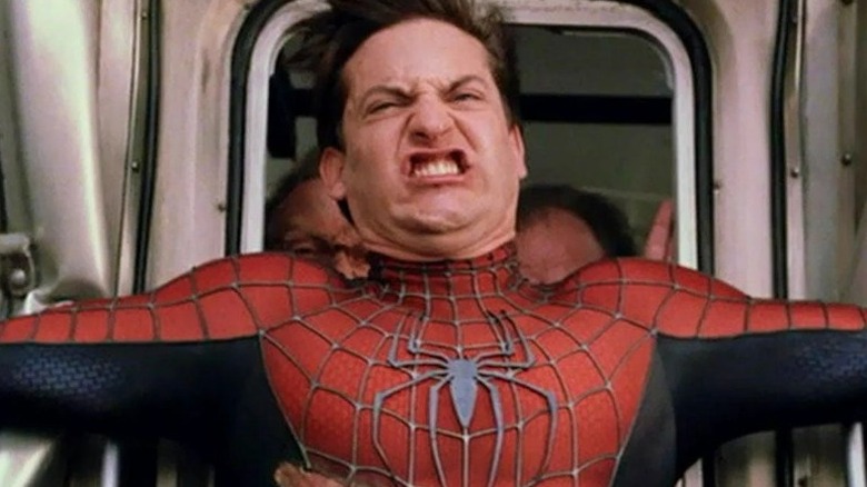 Spider-Man holding back a train