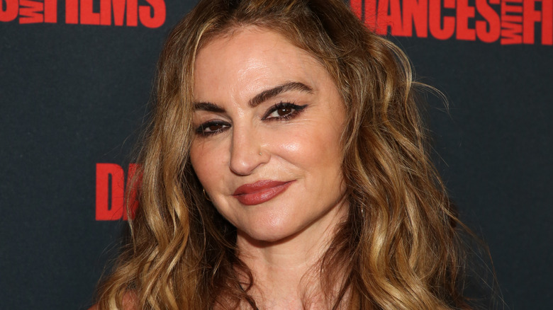Drea de Matteo black and red background