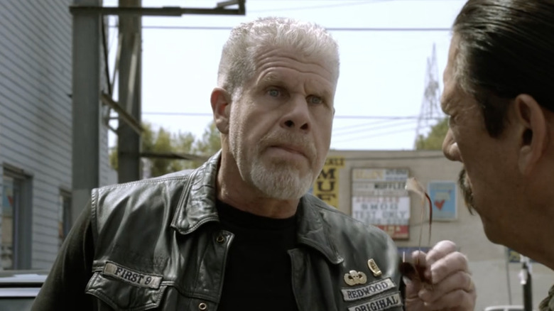 Clay Morrow wearing Leather cut holding sunglasses