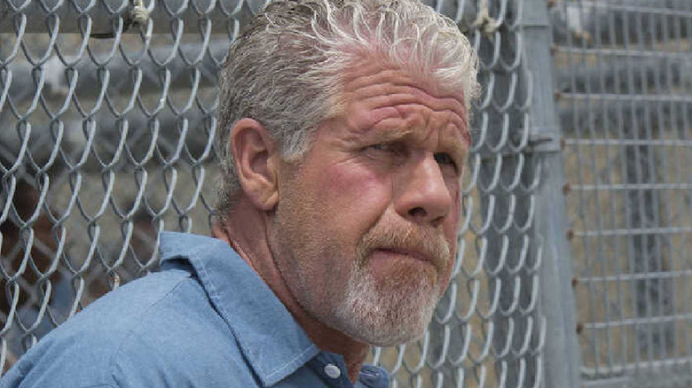 Clay Morrow leaning on fence