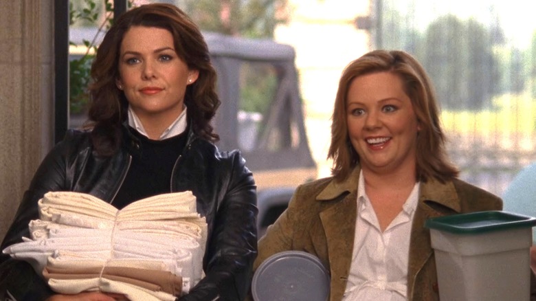 Gilmore Girls' Lorelai and Sookie holding catering supplies