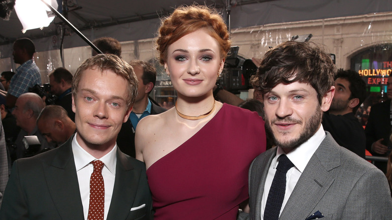 Alfie Allen, Sophie Turner, and Iwan Rheon at an event