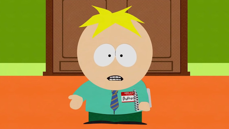 Butters wearing a tie and holding a notebook