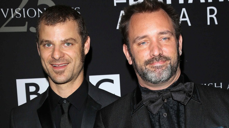 Matt Stone and Trey Parker smiling and wearing black