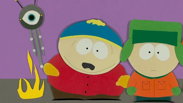 Cartman standing next to an alien probe and Kyle