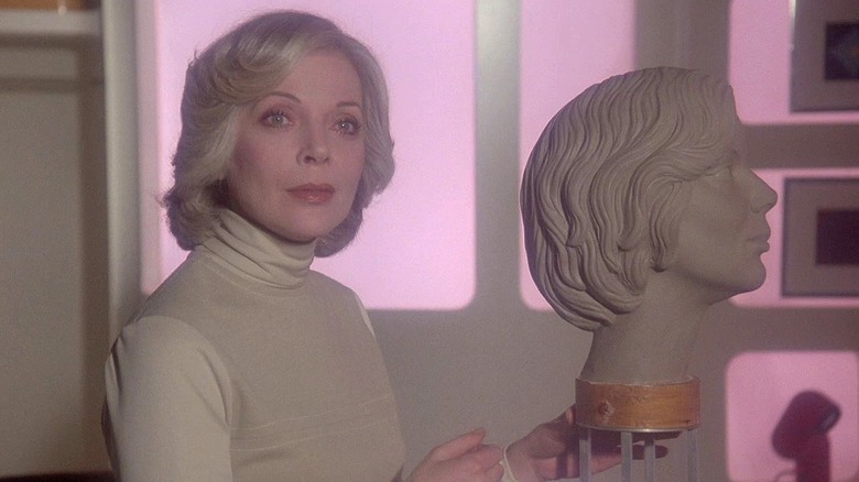 Dr. Russell fiddles with a sculpture of her own head in Space:1999