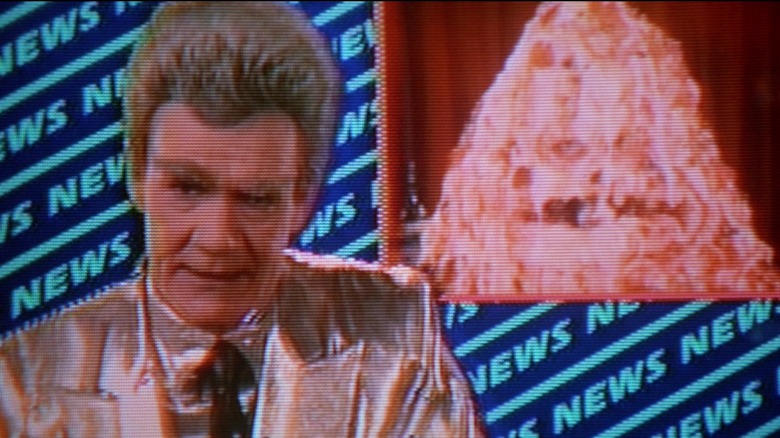 Jack Riley as a newscaster