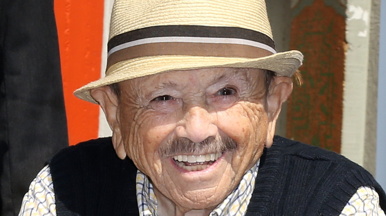 Jerry Maren wears a hat