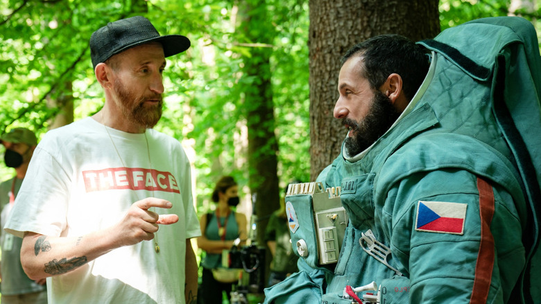 Renck stands next to Sandler on set
