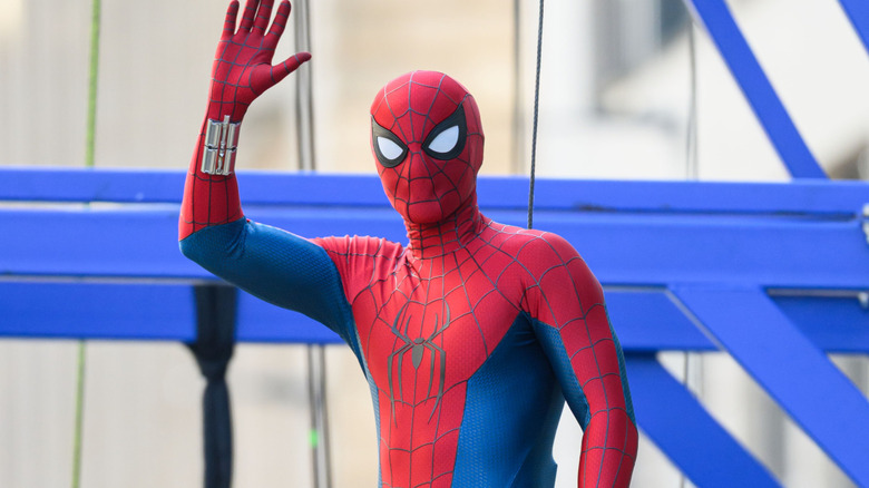 Tom Holland dressed as Spider-Man and waving on Spider-Man: Brand New Day set