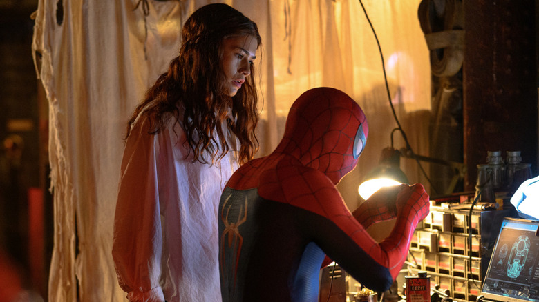 MJ looking over Spider-Man's shoulder as he works in Spider-Man: Brand New Day