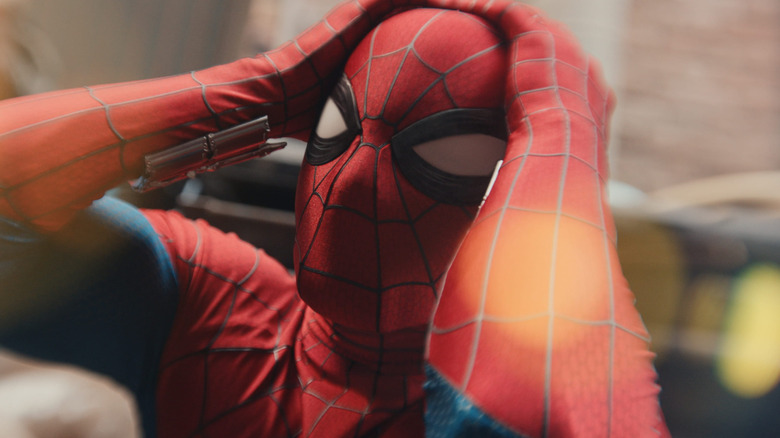 Spider-Man holding his head in 