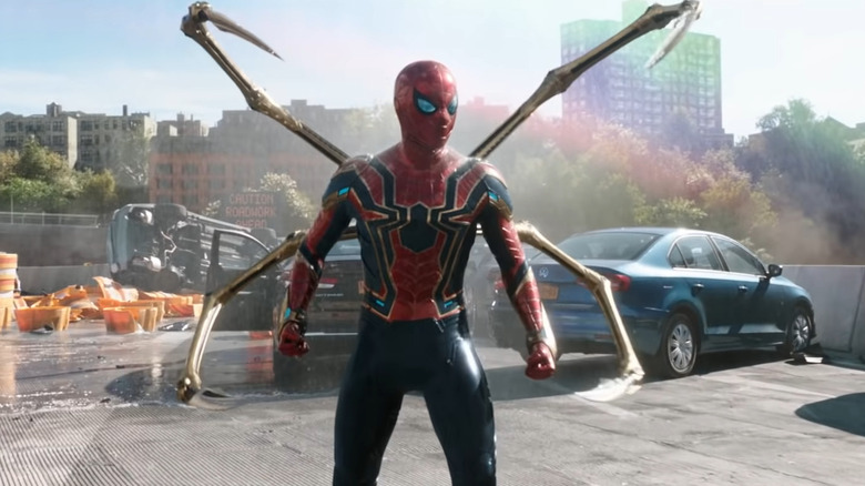 Peter Parker stands next to a car on a highway