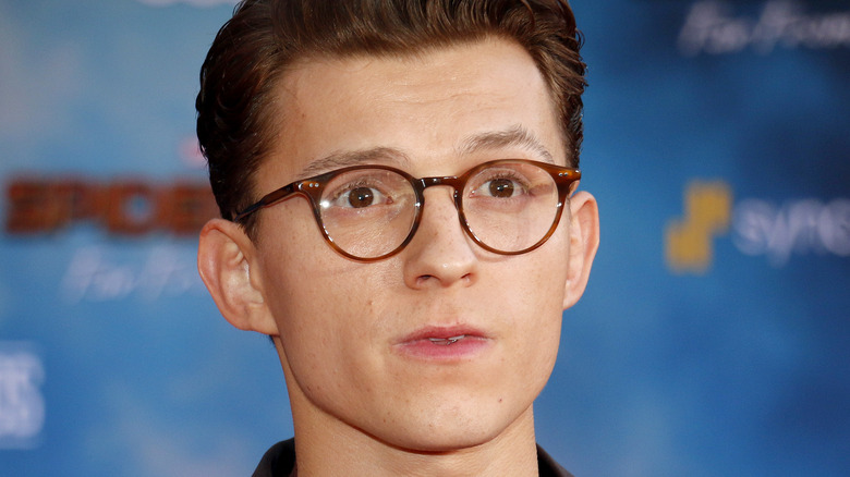 Tom Holland wearing glasses