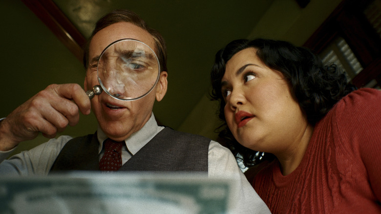 Ben Reilly using a magnifying glass as Janet watches in Spider-Noir