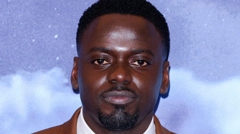 Daniel Kaluuya posing on red carpet for Nope