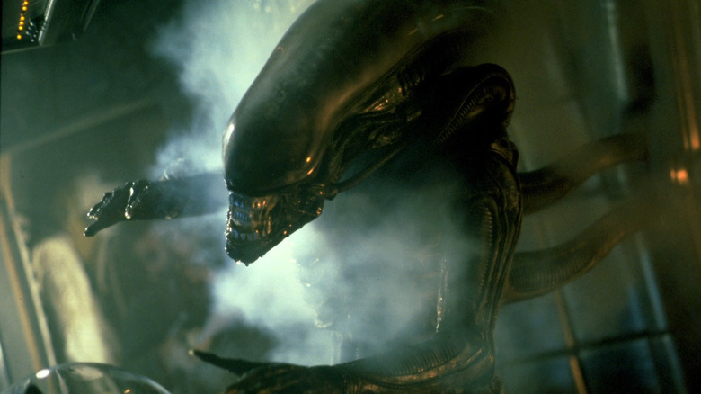 A xenomorph emerging through steam to attack in Alien (1979)
