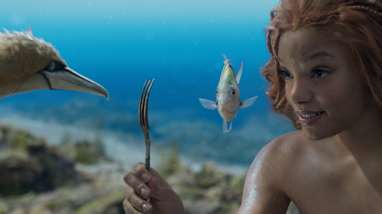 Scuttle, Flounder, and Ariel looking at her found fork