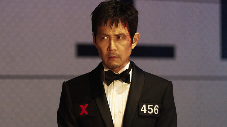 Gi-hun side-eyeing the other finalists in Squid Game (2025)
