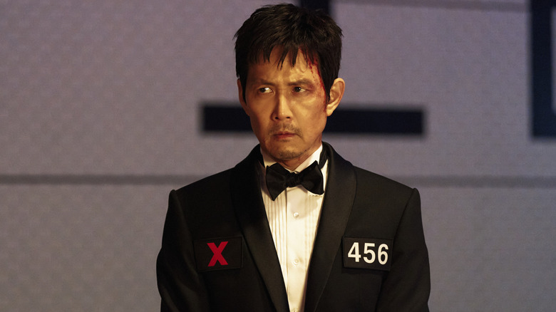 Gi-hun in a tuxedo with his number on it in Squid Game