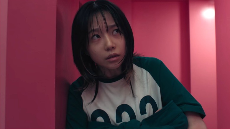 Jun-hee holding her baby in stairwell on Squid Game (2025)