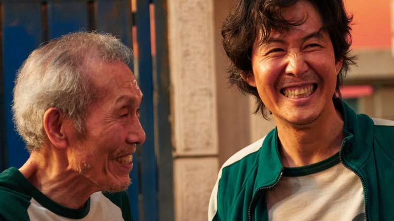 Player 456 and Player 001 laughing together