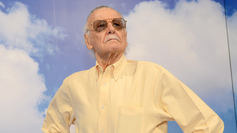 Stan Lee poses with arms on hips