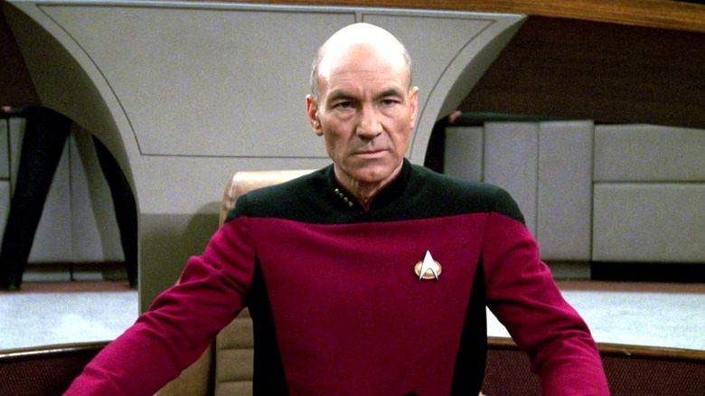 Picard grimacing in his chair