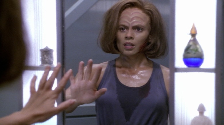 B'Elanna Torres looking thoughtful and confronting her mirror self in Star Trek: Voyager