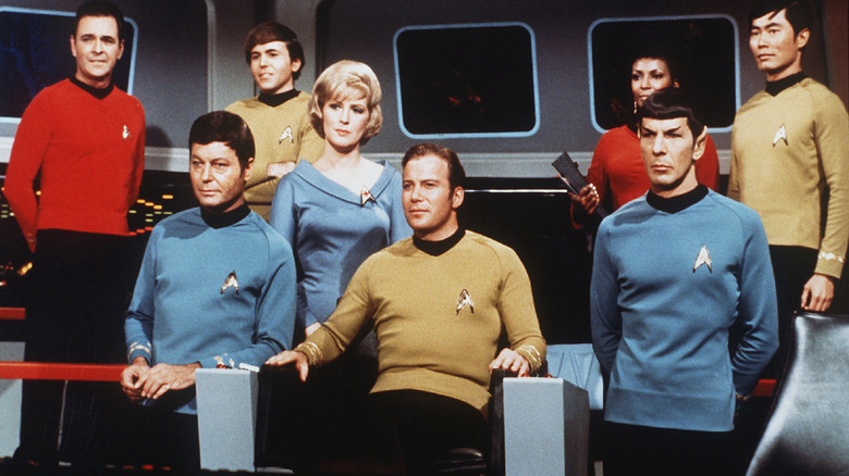 The Starship Enterprise crew sitting assembled together on the bridge of the ship