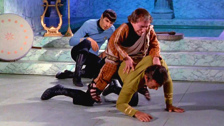 Spock looks on as Alexander rides Captain Kirk in Plato's Stepchildren (1968)