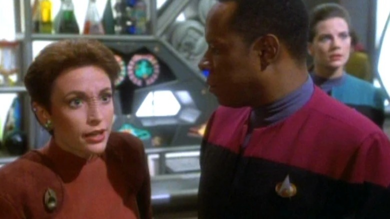 Kira Nerys looking agitated while Benjamin Sisko watches on Star Trek: Deep Space Nine