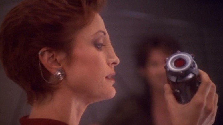Kira Nerys holding a device on Star Trek: Deep Space Nine