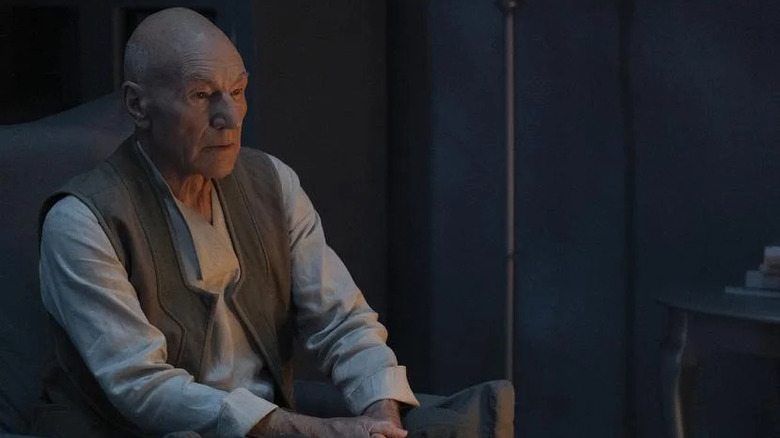 Picard sits in the light of a lamp