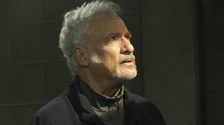 Q looks up in surprise in "Mercy" (2022)