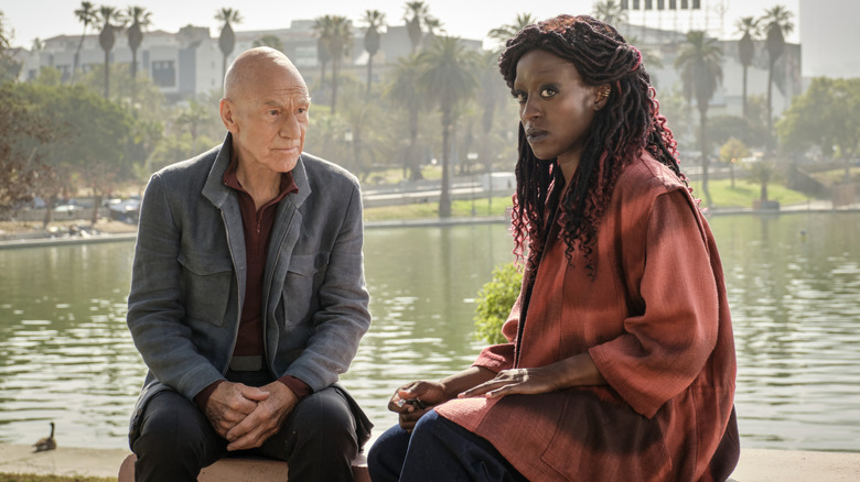 Jean-Luc Picard and young Guinan sit by a pond in "Watcher" (2022)
