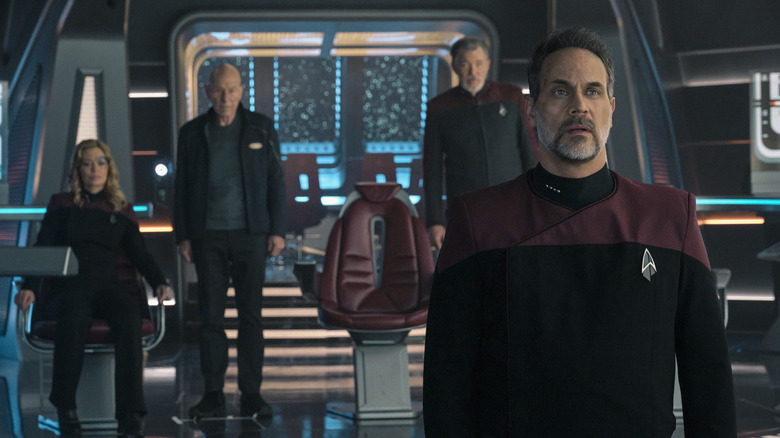 Seven of Nine, Picard, Riker, and Shaw look on