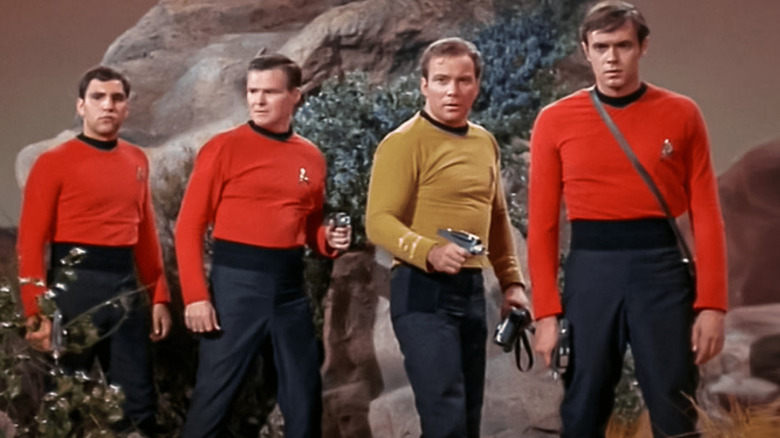 Kirk leads three red shirts on a planet in Star Trek