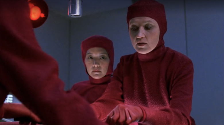 Two doctors operate on a patient in Star Trek: Deep Space Nine