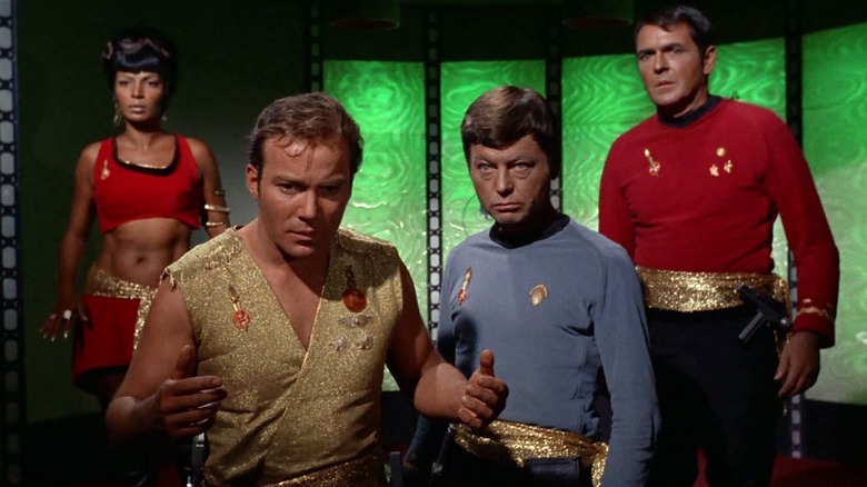 Uhura, Kirk, McCoy, and Scott looking hesitant in Star Trek: The Original Series